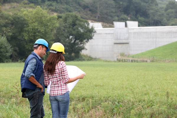 Business people checking plan on construction site-1