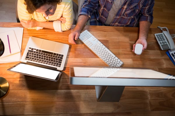 Businesswoman and colleague working at their desk in the office