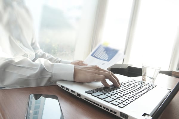 business man hand working on laptop computer on wooden desk as concept-1