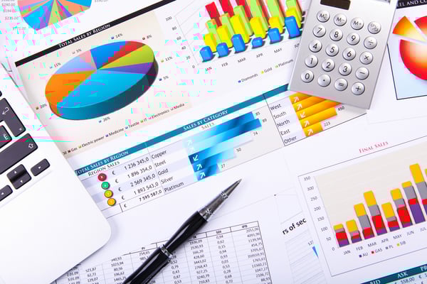 Financial paper charts and graphs on the table