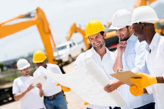 Group of architects and engineers at a building site looking at blueprints.jpeg