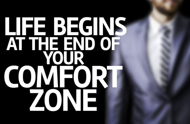 Life Begins at the end of Your Comfort Zone written on a board with a business man on background.jpeg