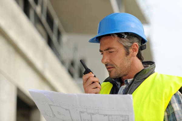 Portrait of construction manager using walkie-talkie