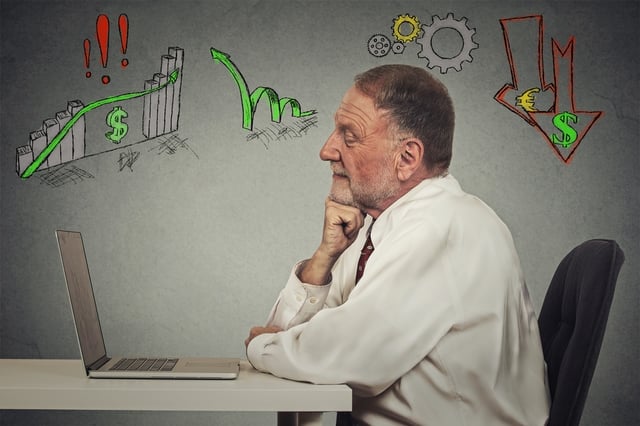 Side profile view senior business man working on computer isolated on grey wall background. Anticipation of financial crisis, bad, poor economy concept. Corporate employee thinking, making decisions..jpeg