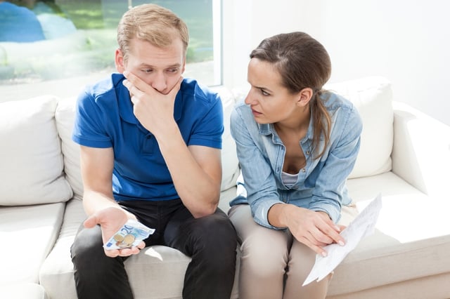 Young couple having problems with paying high bills.jpeg
